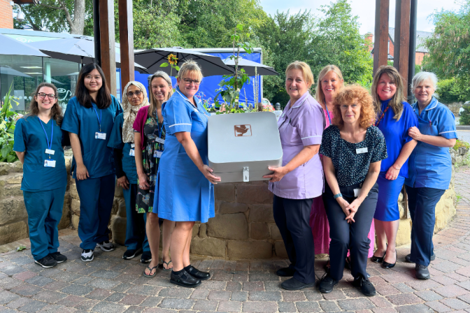 Nightingale House Hospice Clinical Team holding the time capsule