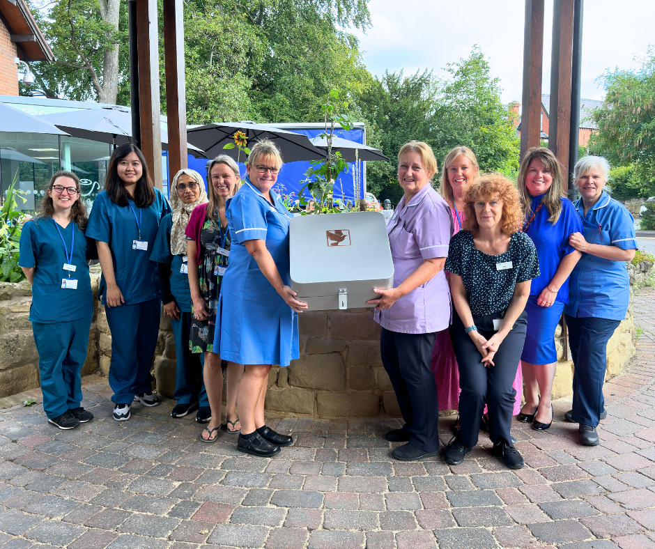 Nightingale House Hospice Clinical Team holding the time capsule